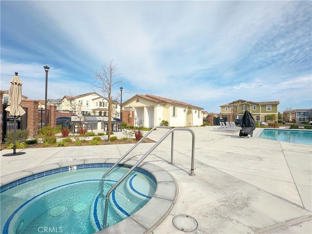 view of swimming pool featuring a community hot tub