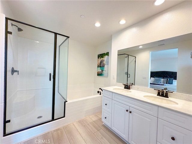 bathroom with vanity and separate shower and tub