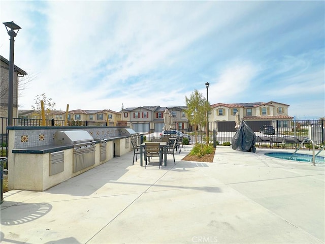 view of patio / terrace with area for grilling, a swimming pool, and grilling area