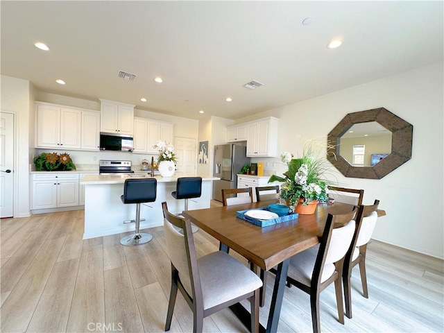 dining room with light wood-type flooring