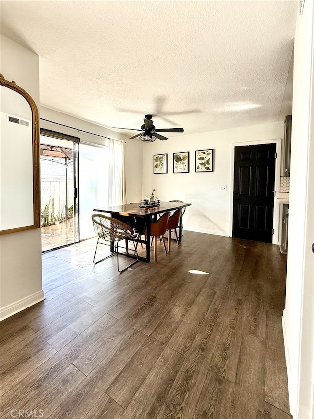 dining area with a textured ceiling, dark hardwood / wood-style floors, and ceiling fan