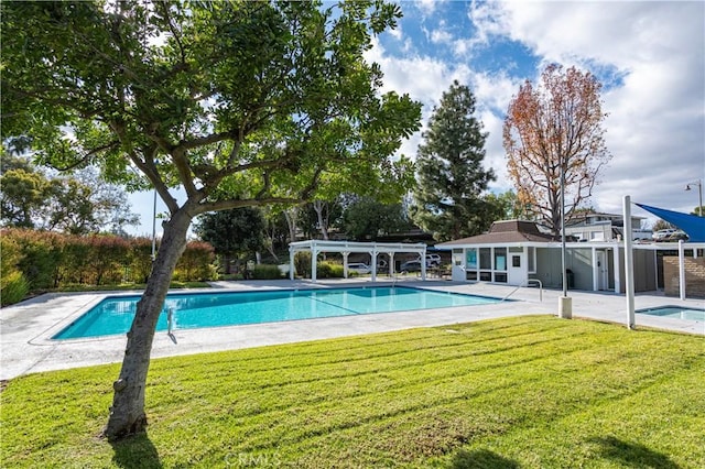 view of pool featuring a yard and a patio area