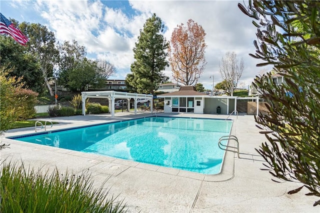 view of swimming pool featuring a patio and a pergola