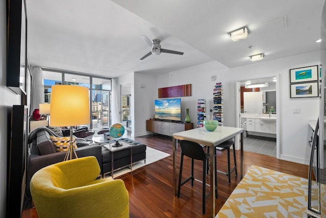 living room with ceiling fan, sink, and hardwood / wood-style floors