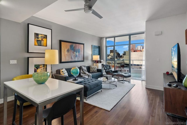 living room with dark wood-type flooring, a wall of windows, and ceiling fan