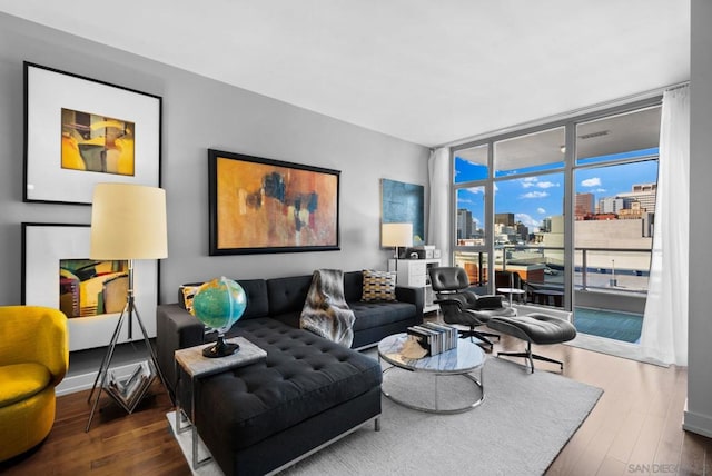 living room featuring floor to ceiling windows and hardwood / wood-style floors