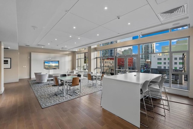 interior space featuring dark hardwood / wood-style floors, a kitchen breakfast bar, a kitchen island, and a wealth of natural light