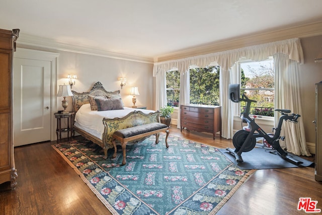 bedroom with ornamental molding and dark hardwood / wood-style flooring