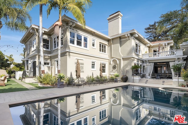 exterior space with a pool with hot tub and a patio