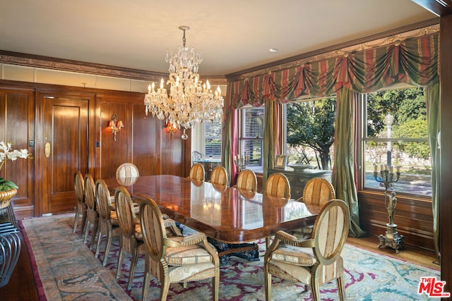 dining area with hardwood / wood-style flooring and a notable chandelier