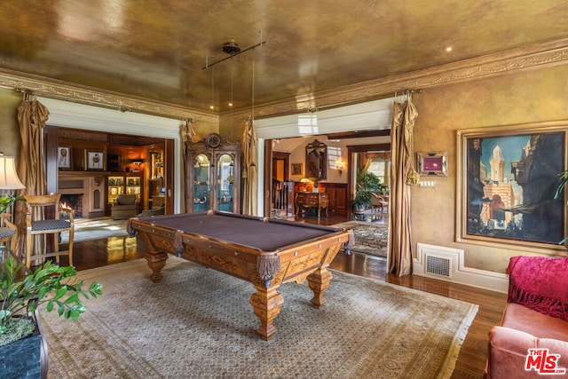 playroom featuring pool table, ornamental molding, and dark hardwood / wood-style floors