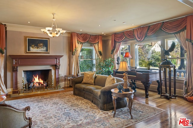 living room featuring hardwood / wood-style flooring, ornamental molding, and an inviting chandelier