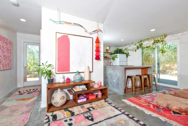 interior space with white refrigerator and access to exterior