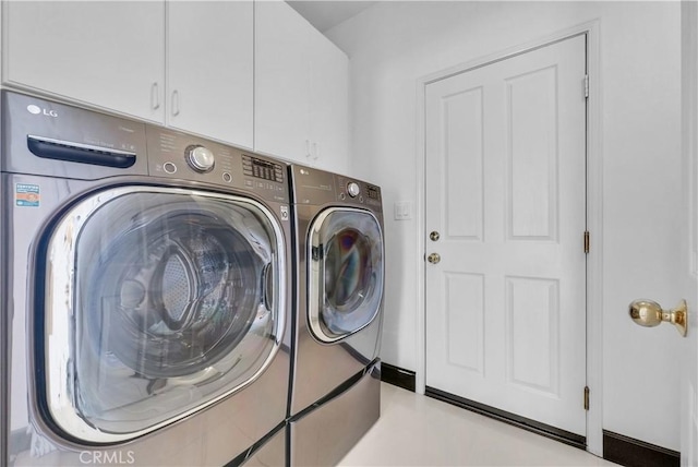 laundry room featuring cabinets and separate washer and dryer