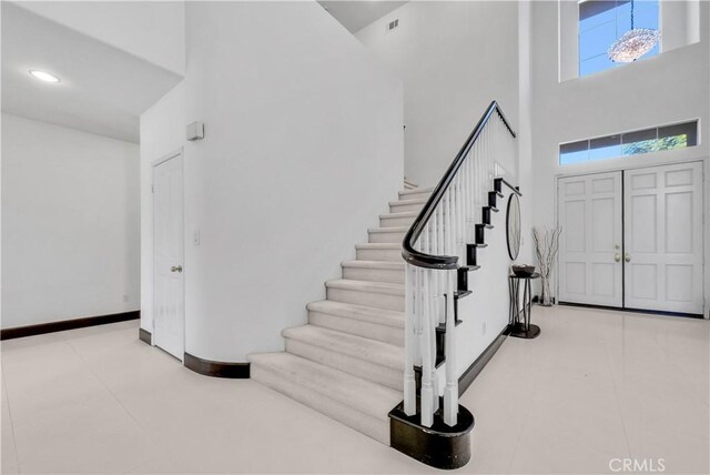 foyer entrance with a towering ceiling