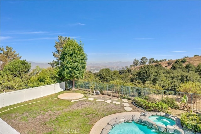 view of swimming pool featuring an in ground hot tub and a mountain view