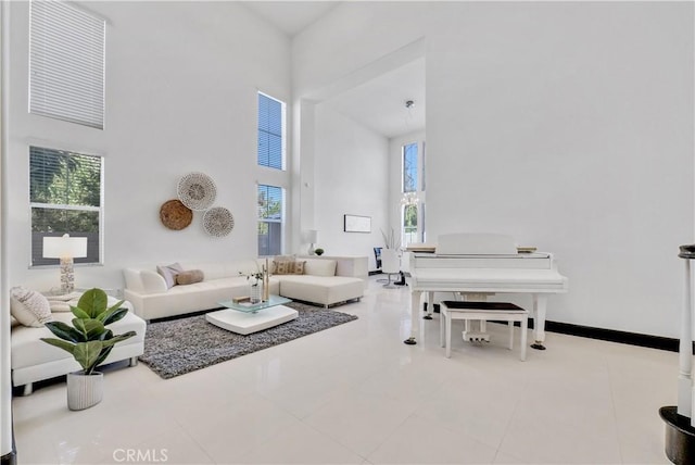 living room with tile patterned flooring and a towering ceiling