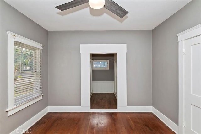 unfurnished room with ceiling fan and dark hardwood / wood-style floors