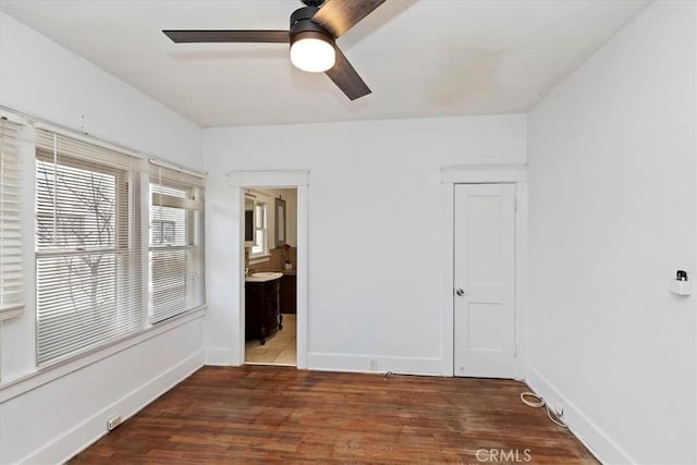 unfurnished room with dark hardwood / wood-style floors and ceiling fan