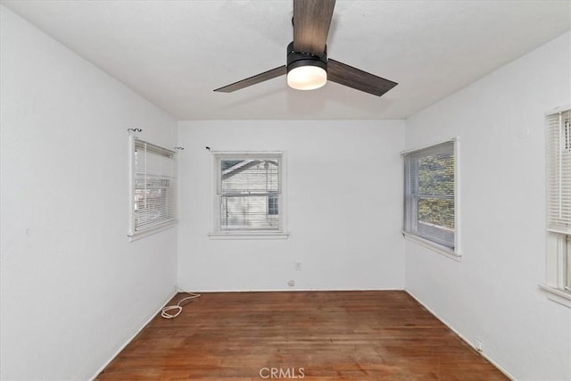 empty room featuring ceiling fan and dark hardwood / wood-style floors