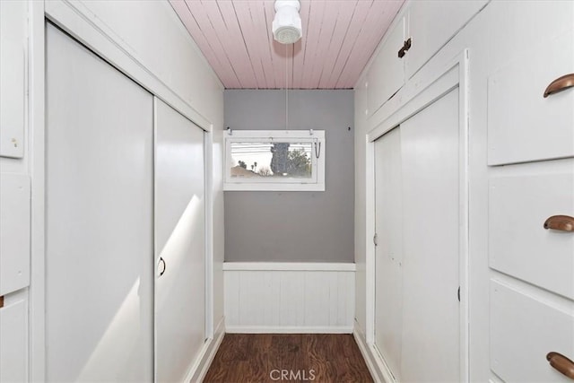 hall featuring dark hardwood / wood-style floors and wooden ceiling