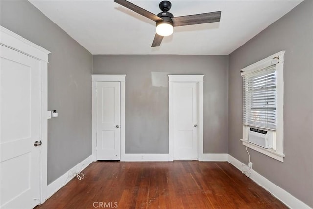 unfurnished bedroom with dark hardwood / wood-style floors, cooling unit, and ceiling fan