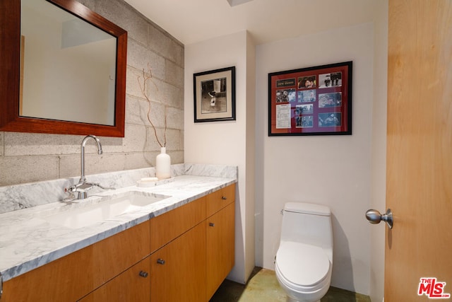 bathroom featuring vanity and toilet