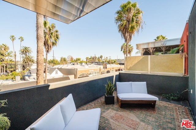 view of patio featuring a balcony and an outdoor hangout area