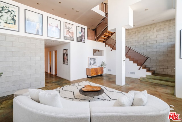 living room featuring a towering ceiling