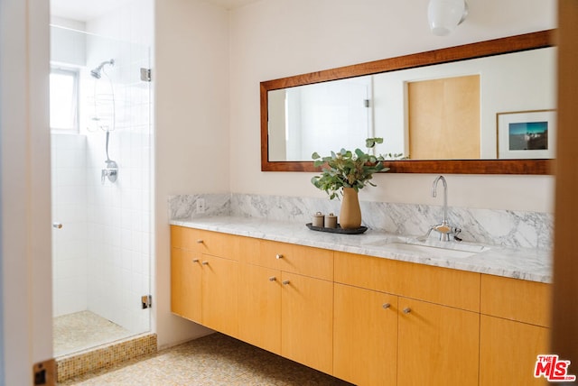 bathroom with vanity and a shower with shower door