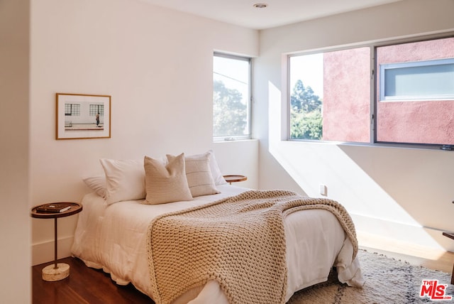 bedroom with hardwood / wood-style flooring