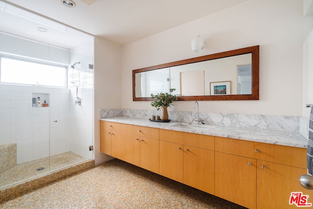 bathroom featuring vanity and a shower with shower door