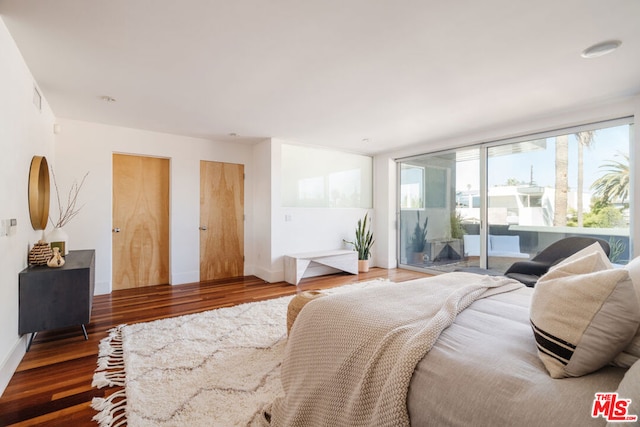 bedroom featuring access to outside and dark hardwood / wood-style flooring