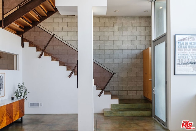 staircase with concrete flooring