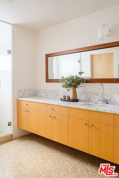 bathroom featuring vanity and an enclosed shower