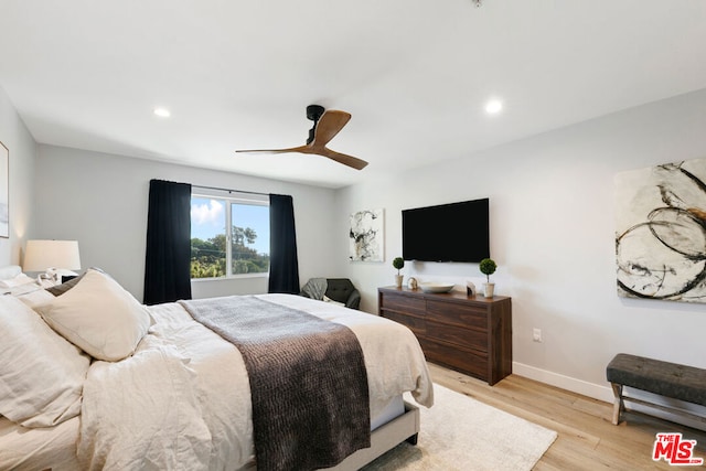 bedroom with ceiling fan and light wood-type flooring