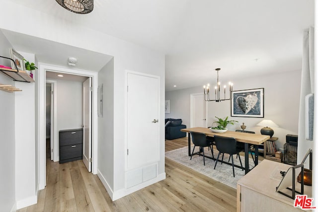 interior space featuring light hardwood / wood-style flooring and a notable chandelier