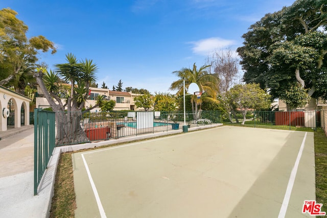 view of basketball court featuring a community pool