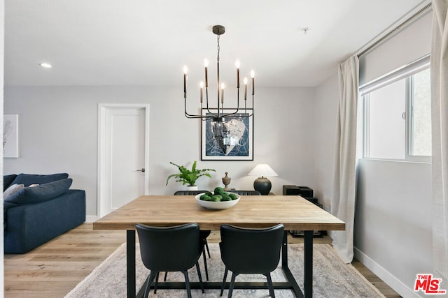 dining room featuring a notable chandelier and light hardwood / wood-style floors