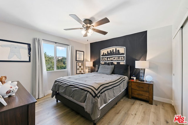 bedroom featuring a closet, ceiling fan, and light wood-type flooring