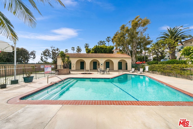 view of swimming pool featuring a patio area