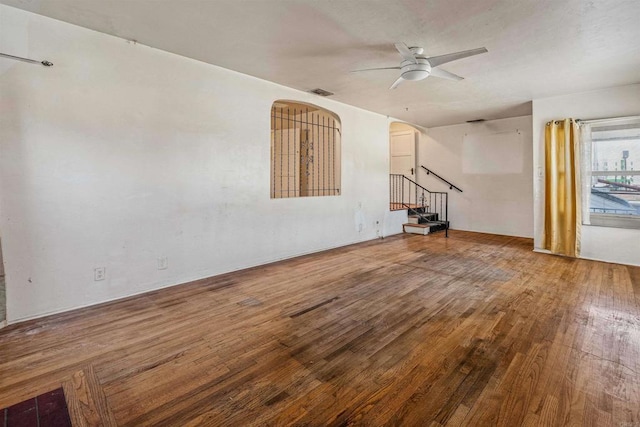 unfurnished living room with hardwood / wood-style flooring and ceiling fan