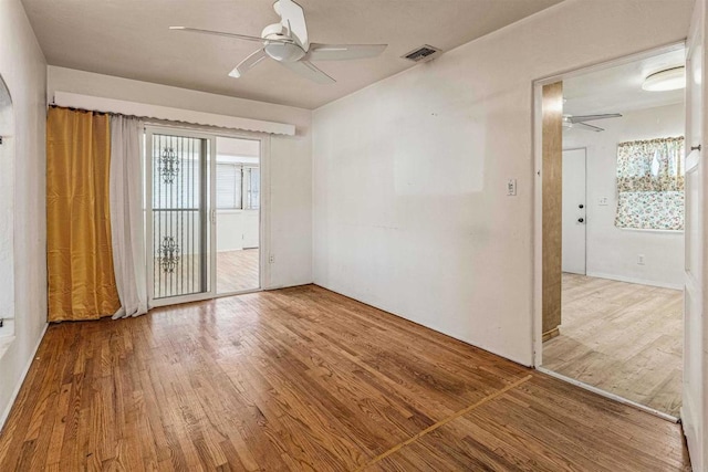 spare room with hardwood / wood-style flooring and ceiling fan