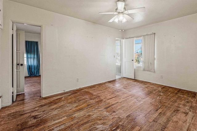 unfurnished room featuring dark hardwood / wood-style flooring and ceiling fan