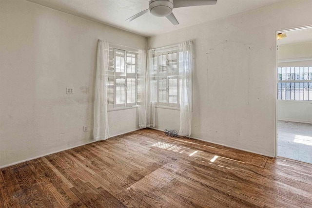 empty room featuring hardwood / wood-style flooring and ceiling fan