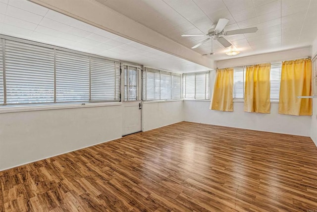 empty room with hardwood / wood-style floors and ceiling fan