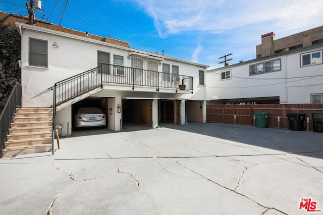 rear view of property with a garage