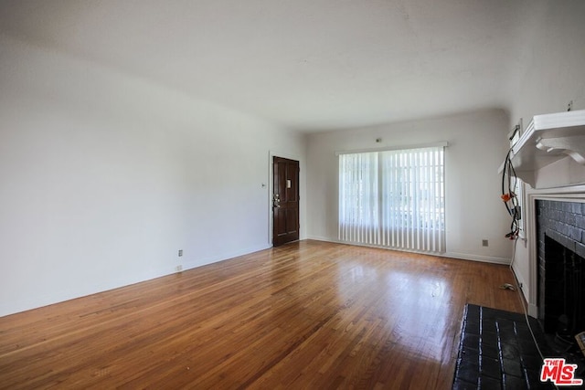 unfurnished living room featuring hardwood / wood-style floors