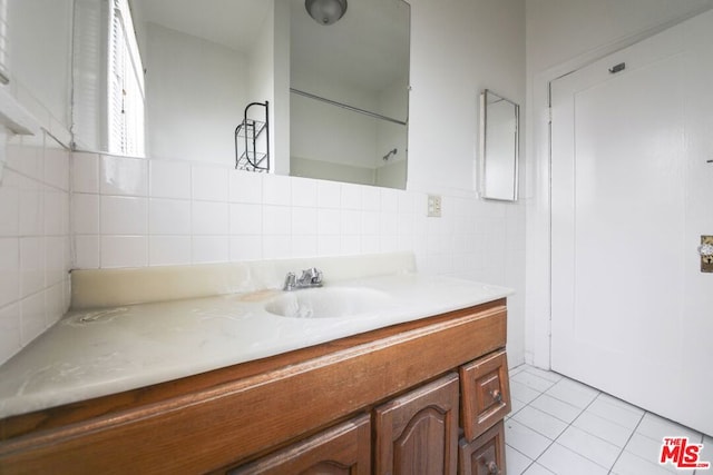 bathroom with vanity, tile patterned floors, and tile walls