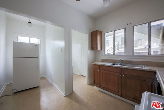 kitchen with white refrigerator, sink, and ceiling fan